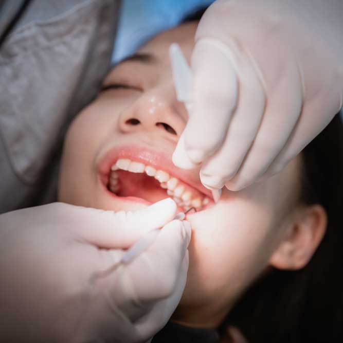 Girl getting her teeth examined