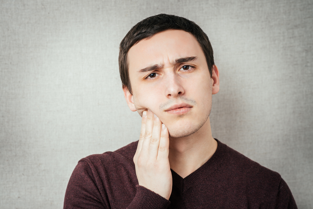 Man holding his jaw in pain