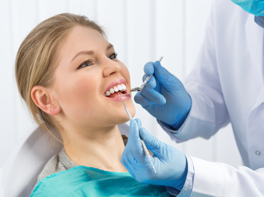 Young woman getting her teeth checked