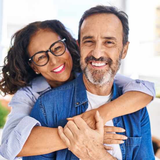 older couple hugging each other and smiling